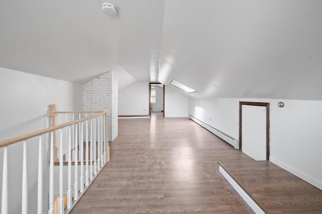 5 Northgate Rd, Chelmsford, MA 01824 - additional living space with a baseboard heating unit, vaulted ceiling, and wood finished floors