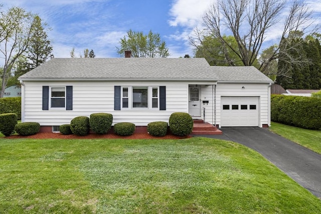 ranch-style house featuring an attached garage, driveway, a chimney, and a front lawn
