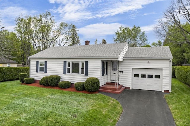 single story home featuring a garage, driveway, a chimney, a shingled roof, and a front yard