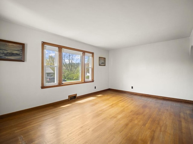 unfurnished room featuring light wood finished floors and baseboards