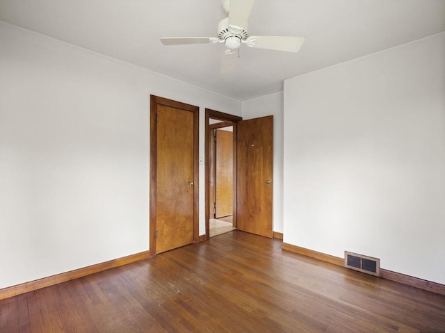 empty room featuring baseboards and wood finished floors