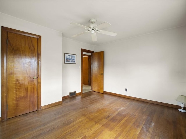 unfurnished bedroom featuring wood finished floors, baseboards, and a ceiling fan