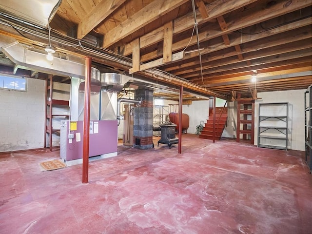 basement with heating fuel, heating unit, and stairway