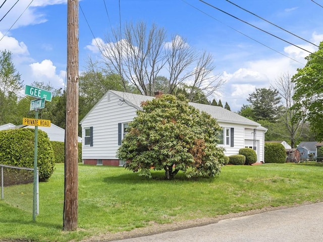 view of property hidden behind natural elements with a front lawn, a chimney, and a garage