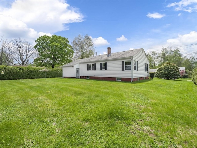 rear view of property with a lawn and a chimney