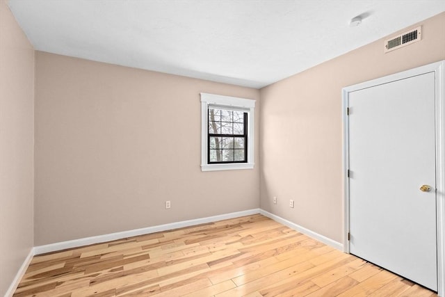 spare room with light hardwood / wood-style floors