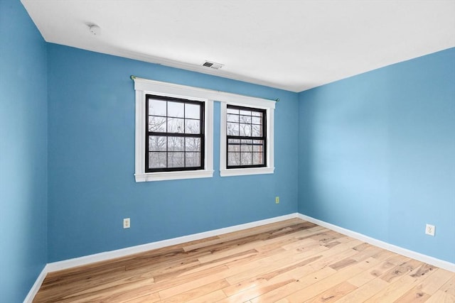 empty room with light hardwood / wood-style floors