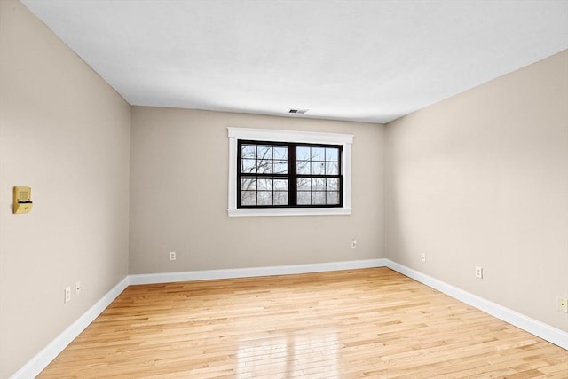 empty room with light hardwood / wood-style flooring