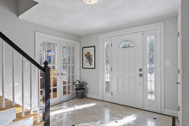 entryway featuring french doors and crown molding