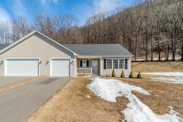 ranch-style house featuring aphalt driveway, a porch, an attached garage, and a shingled roof