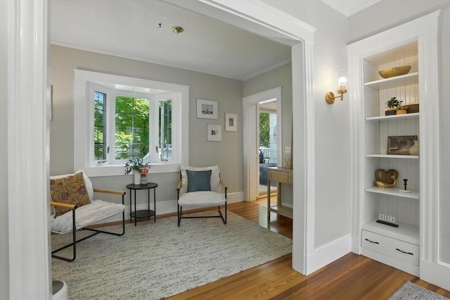 31 Dudley St, North Andover, MA 01845 - sitting room featuring dark wood finished floors, ornamental molding, and built in shelves