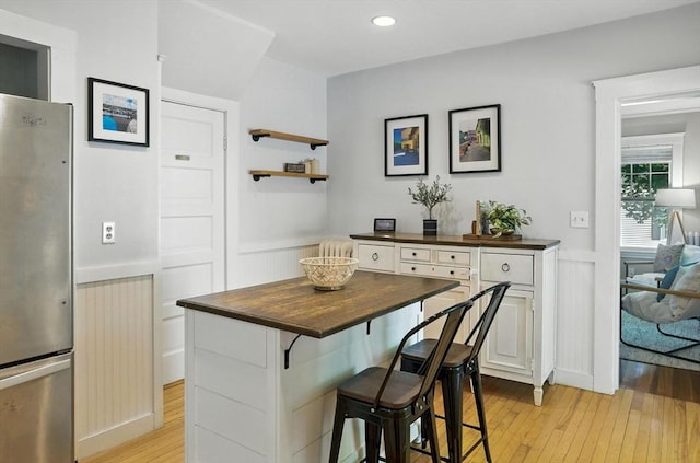 31 Dudley St, North Andover, MA 01845 - kitchen featuring freestanding refrigerator, butcher block countertops, light wood-style floors, wainscoting, and white cabinetry