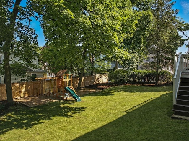 31 Dudley St, North Andover, MA 01845 - fenced backyard featuring a playground and stairs