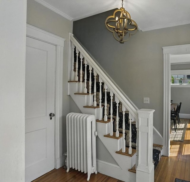 31 Dudley St, North Andover, MA 01845 - stairway with radiator heating unit, a chandelier, wood finished floors, and crown molding