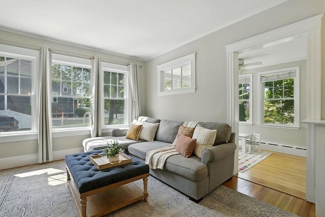 31 Dudley St, North Andover, MA 01845 - living area featuring plenty of natural light, a baseboard heating unit, wood finished floors, ceiling fan, and crown molding