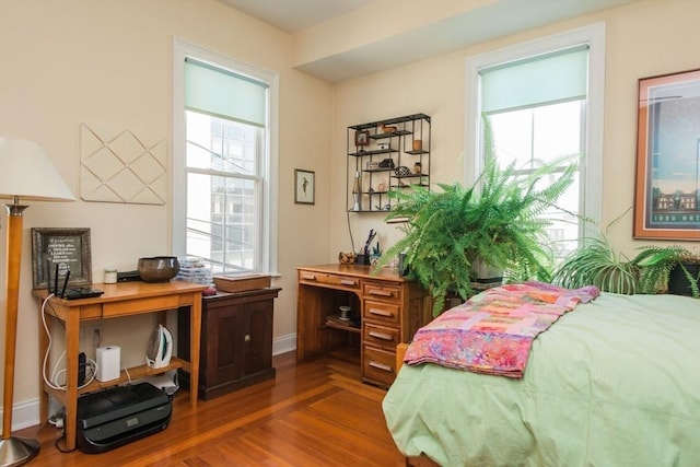 bedroom with baseboards and wood finished floors