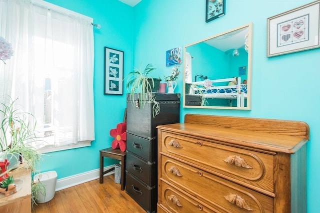 interior space featuring baseboards and wood finished floors