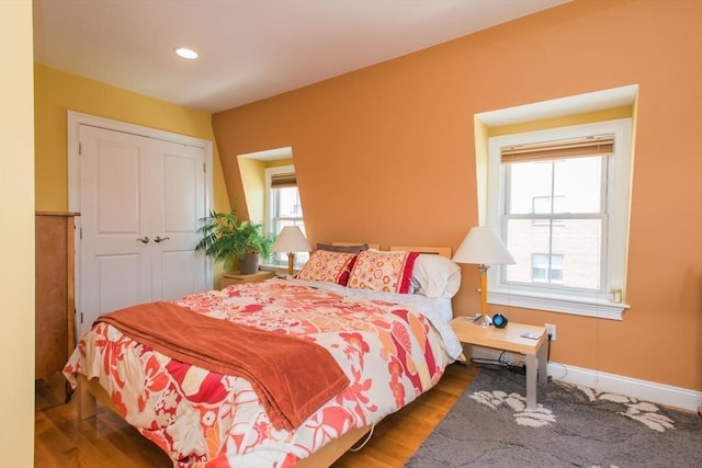 bedroom with recessed lighting, baseboards, and wood finished floors