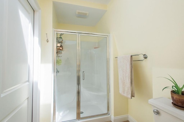 bathroom featuring baseboards and a stall shower