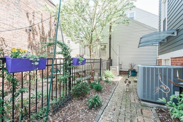 view of yard featuring fence and cooling unit