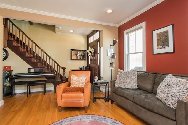 living area with stairway, baseboards, ornamental molding, and wood finished floors