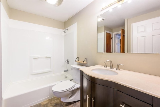 bathroom featuring toilet, vanity, and bathing tub / shower combination