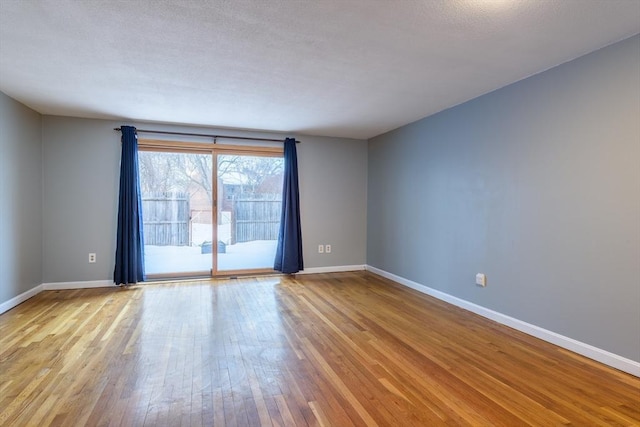 empty room with light wood-style floors and baseboards