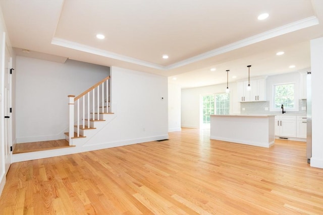 776 Allen St, Dartmouth, MA 02747 - unfurnished living room featuring light wood-type flooring, crown molding, recessed lighting, a raised ceiling, and stairs