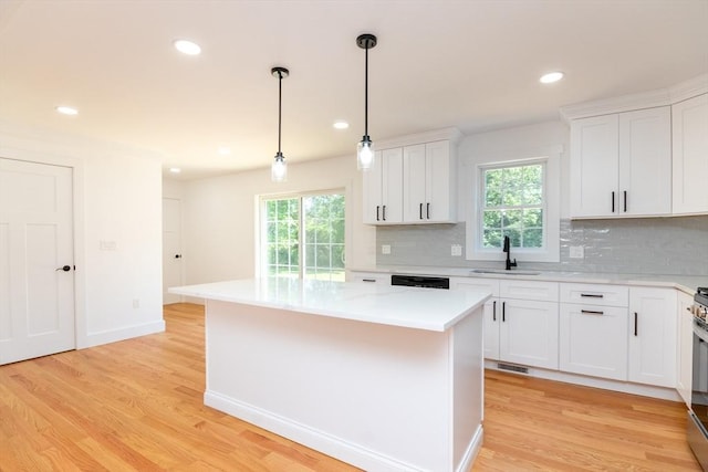 776 Allen St, Dartmouth, MA 02747 - kitchen with tasteful backsplash, a kitchen island, light countertops, light wood-style floors, and recessed lighting