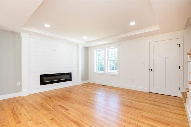776 Allen St, Dartmouth, MA 02747 - unfurnished living room featuring a tray ceiling, a large fireplace, light wood-type flooring, recessed lighting, and ornamental molding