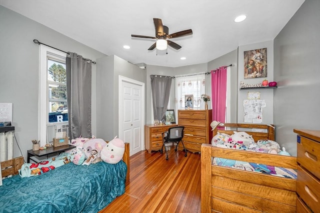 bedroom featuring ceiling fan, wood-type flooring, a closet, and recessed lighting