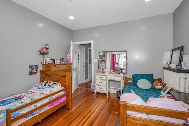 bedroom with wood finished floors and recessed lighting