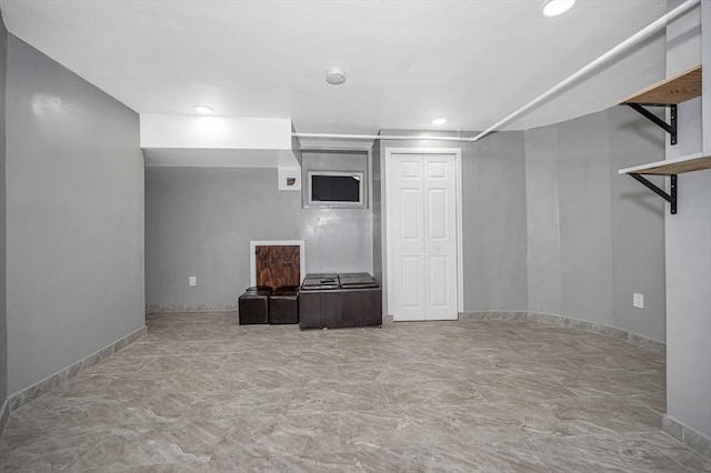 finished basement featuring baseboards and recessed lighting
