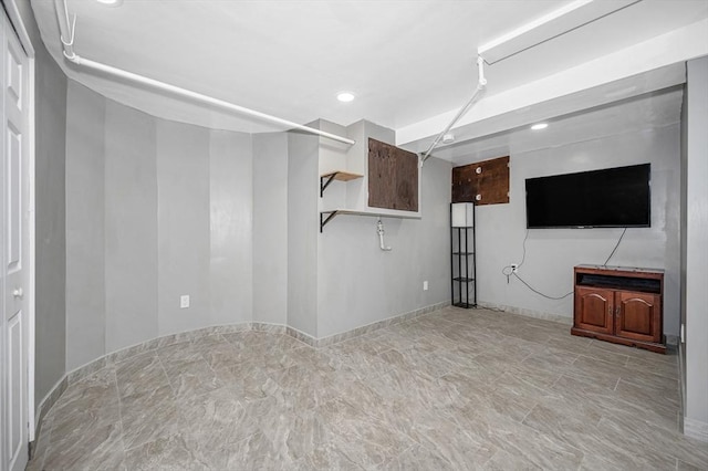 below grade area featuring baseboards and recessed lighting