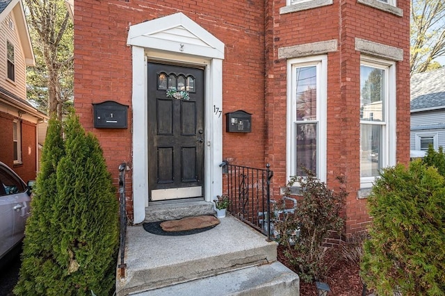 property entrance featuring brick siding
