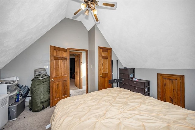 carpeted bedroom featuring a ceiling fan and vaulted ceiling