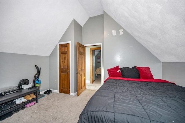 bedroom featuring vaulted ceiling, light colored carpet, and baseboards