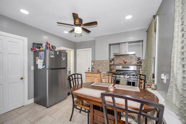 dining space with a ceiling fan and baseboards