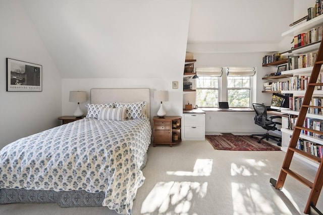 bedroom featuring vaulted ceiling and light carpet