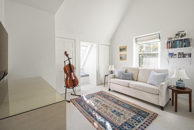 living room featuring light colored carpet and high vaulted ceiling