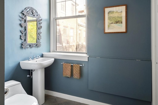 bathroom with toilet and tile patterned flooring