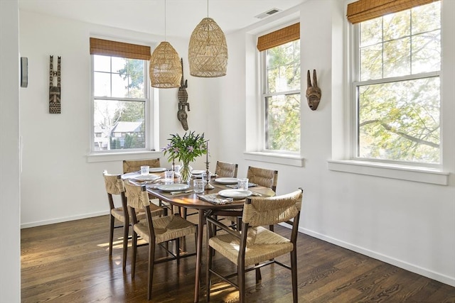 dining room with dark hardwood / wood-style flooring