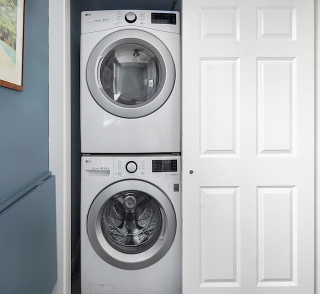 washroom featuring stacked washer and dryer