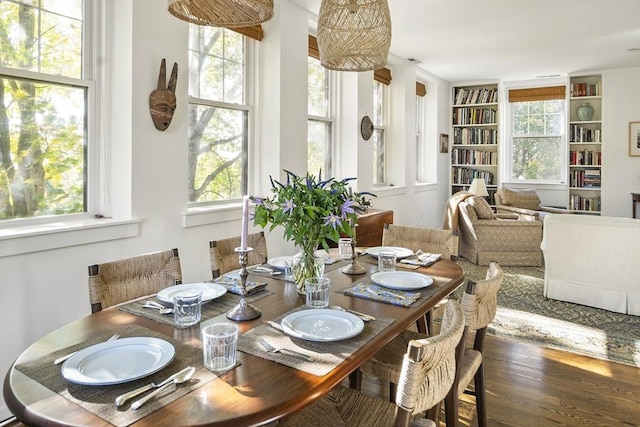 dining area with hardwood / wood-style flooring and built in shelves