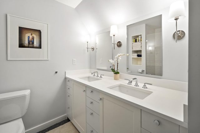 bathroom featuring vanity, tile patterned floors, and toilet