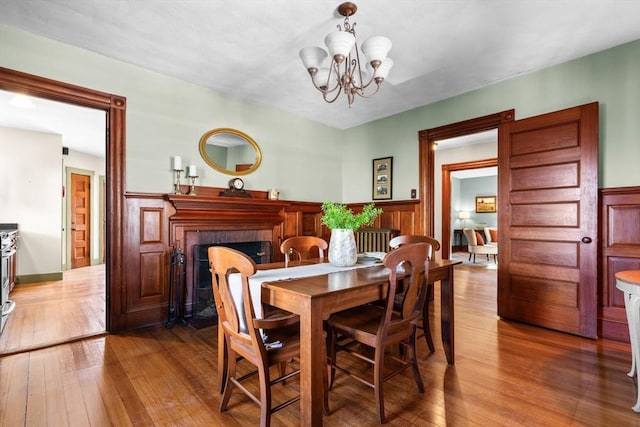 dining area with hardwood / wood-style flooring and a chandelier