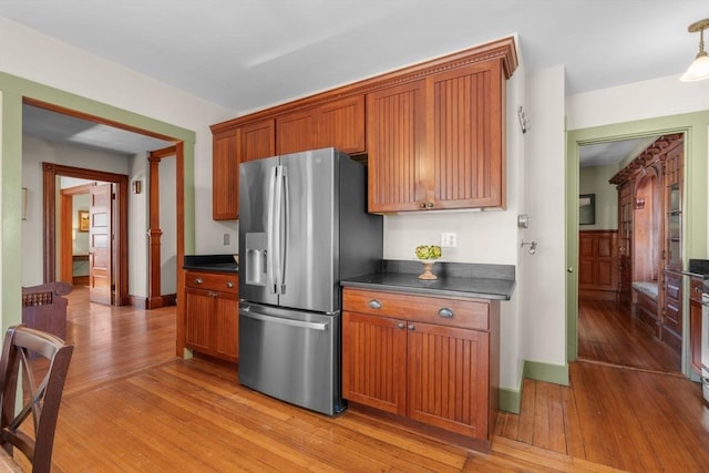 kitchen with stainless steel fridge with ice dispenser and light hardwood / wood-style flooring