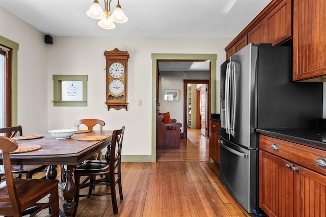 dining space featuring hardwood / wood-style floors and a notable chandelier