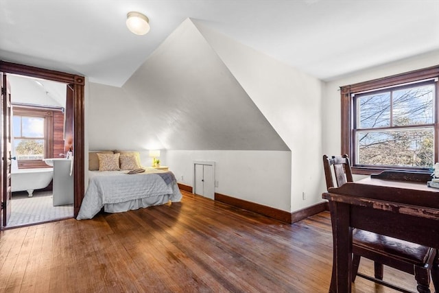 bedroom featuring lofted ceiling and dark hardwood / wood-style floors