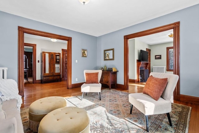 sitting room featuring radiator and light hardwood / wood-style floors